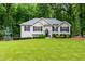 Charming single-story home with a well-manicured lawn and landscaping, nestled among mature shade trees at 5930 Shannon Drive Dr, Cumming, GA 30040