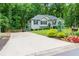 Charming single-story home with lush landscaping, driveway, and a mailbox with colorful flowers at 5930 Shannon Drive Dr, Cumming, GA 30040