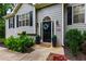 Charming home exterior with a black front door, decorative wreath, well-maintained landscaping, and inviting curb appeal at 5930 Shannon Drive Dr, Cumming, GA 30040