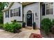Charming home's front entrance featuring a well-manicured yard, landscaping and a welcoming front door at 5930 Shannon Drive Dr, Cumming, GA 30040