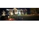 Evening view showcasing a lovely home exterior with manicured lawn and landscaped garden beds at 5930 Shannon Drive Dr, Cumming, GA 30040