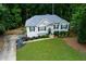 Aerial view of a charming home with a well-manicured lawn and a long driveway at 5930 Shannon Drive Dr, Cumming, GA 30040