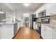 Bright kitchen with stainless steel appliances, granite countertops, and bar seating at 5930 Shannon Drive Dr, Cumming, GA 30040