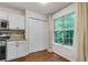 Bright kitchen featuring white cabinets, stainless steel appliances, and natural light at 5930 Shannon Drive Dr, Cumming, GA 30040