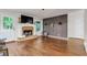 Spacious living room features a stone fireplace, wood floors, and a stylish accent wall at 5930 Shannon Drive Dr, Cumming, GA 30040