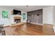 Cozy living room with fireplace, hardwood floors, and stylish accent wall with modern lighting at 5930 Shannon Drive Dr, Cumming, GA 30040