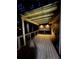 Inviting covered patio with wooden floors and ambient lighting for outdoor relaxation at 5930 Shannon Drive Dr, Cumming, GA 30040