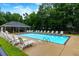 Community pool with chairs and basketball court, surrounded by a fence and mature trees at 5930 Shannon Drive Dr, Cumming, GA 30040