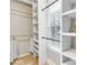 Walk-in closet with custom shelving, window, and a clothing rod for ample storage at 5930 Shannon Drive Dr, Cumming, GA 30040
