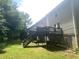 Back exterior of townhouses, featuring wooden decks with stairs overlooking the lawn, providing outdoor living spaces at 8955 Stonebridge Blvd, Douglasville, GA 30134