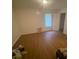 A standard bedroom features light from the windows and wood floors at 8955 Stonebridge Blvd, Douglasville, GA 30134