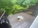 Wooden deck surrounded by lush greenery, perfect for outdoor relaxation and entertaining in a serene setting at 8955 Stonebridge Blvd, Douglasville, GA 30134