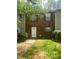 Charming brick townhouse with green shutters and a well-maintained front lawn, creating a welcoming curb appeal at 8955 Stonebridge Blvd, Douglasville, GA 30134