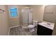 This bathroom features a corner shower with glass doors and a gray vanity at 1127 Renee Dr, Decatur, GA 30035