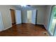 This is a bright bedroom with wood-look floors and open doorways at 1127 Renee Dr, Decatur, GA 30035