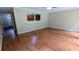 Open living room with hardwood floors and a view of the kitchen at 1127 Renee Dr, Decatur, GA 30035