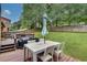 A spacious back deck features an outdoor dining area, overlooking the lush green backyard at 1685 Frazier Park Dr, Decatur, GA 30033