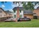 Large backyard with mature trees, a two tiered wooden deck with grill, and brick and siding on the house at 1685 Frazier Park Dr, Decatur, GA 30033