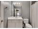 Well-lit bathroom featuring a single sink vanity with gray wall paint and tiled shower-tub combination at 1685 Frazier Park Dr, Decatur, GA 30033