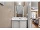 Neutral toned bathroom features a white vanity, a square mirror, and is open to the carpeted living area at 1685 Frazier Park Dr, Decatur, GA 30033