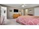 Bedroom includes gray walls, neutral carpet, ceiling fan, TV over a dresser and doorway to bathroom at 1685 Frazier Park Dr, Decatur, GA 30033