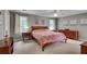 Spacious bedroom features neutral carpet, gray walls, ceiling fan, and an assortment of matching wooden furniture at 1685 Frazier Park Dr, Decatur, GA 30033