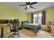 This bright bedroom includes a ceiling fan, desk, and a twin bed at 1685 Frazier Park Dr, Decatur, GA 30033