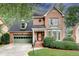 Charming brick home featuring a two-car garage, manicured landscaping, and inviting front entrance at 1685 Frazier Park Dr, Decatur, GA 30033