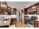 Well-lit kitchen with wooden cabinets, granite countertops, stainless steel appliances, and white subway tile backsplash at 1685 Frazier Park Dr, Decatur, GA 30033