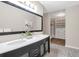Bathroom boasts double sinks, large framed mirror, and stylish tile flooring at 17 Ivy Gates Ne, Atlanta, GA 30342