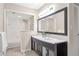 Modern bathroom featuring double sinks, sleek black cabinets, and a separate shower/tub area at 17 Ivy Gates Ne, Atlanta, GA 30342