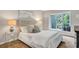 Serene bedroom with large window, plush bedding, and elegant decor at 17 Ivy Gates Ne, Atlanta, GA 30342