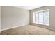 Bright bedroom with a large window and neutral carpet at 17 Ivy Gates Ne, Atlanta, GA 30342