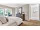 Cozy bedroom featuring a large window seat, comfortable bed, and dresser at 17 Ivy Gates Ne, Atlanta, GA 30342