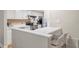 Kitchen with white cabinets and breakfast bar with seating at 17 Ivy Gates Ne, Atlanta, GA 30342