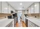 The kitchen features white cabinets, stainless appliances, and hardwood floors at 17 Ivy Gates Ne, Atlanta, GA 30342