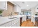 Bright kitchen featuring white cabinets, stainless steel appliances and hardwood floors at 17 Ivy Gates Ne, Atlanta, GA 30342