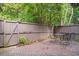 Private brick patio surrounded by a wooden fence and lush greenery at 17 Ivy Gates Ne, Atlanta, GA 30342
