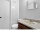 Standard bathroom featuring a single sink, a wall mirror, and a toilet at 504 Rock Meadow Dr, Stone Mountain, GA 30088