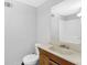 Neutral-colored bathroom featuring a vanity and a toilet, with a shower and tub in the background at 504 Rock Meadow Dr, Stone Mountain, GA 30088