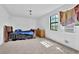 Bedroom with a queen bed, carpet flooring, natural lighting, and black trim windows at 504 Rock Meadow Dr, Stone Mountain, GA 30088