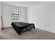 Bedroom features a window, carpeted floors, and a bed with black sheets at 504 Rock Meadow Dr, Stone Mountain, GA 30088