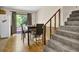 Cozy dining area with wood floors, sliding glass doors, and staircase at 504 Rock Meadow Dr, Stone Mountain, GA 30088