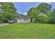 A single-story home with a green lawn, driveway and a parked car on a sunny day at 504 Rock Meadow Dr, Stone Mountain, GA 30088