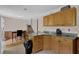 Functional kitchen with granite counters, wooden cabinets, and dining area in the background at 504 Rock Meadow Dr, Stone Mountain, GA 30088