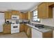 Traditional kitchen features wooden cabinets, granite countertops, and modern appliances at 504 Rock Meadow Dr, Stone Mountain, GA 30088