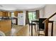 Eat-in kitchen with granite counters, wood cabinets, and access to the dining area at 504 Rock Meadow Dr, Stone Mountain, GA 30088