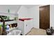 Compact laundry room features a washer, dryer, and shelving for storage at 504 Rock Meadow Dr, Stone Mountain, GA 30088