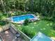View of a backyard deck, pool, landscaping and yard that offers both relaxation and entertainment at 5357 Highway 81, Loganville, GA 30052