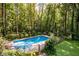 Private swimming pool surrounded by lush trees and landscaping at 5357 Highway 81, Loganville, GA 30052
